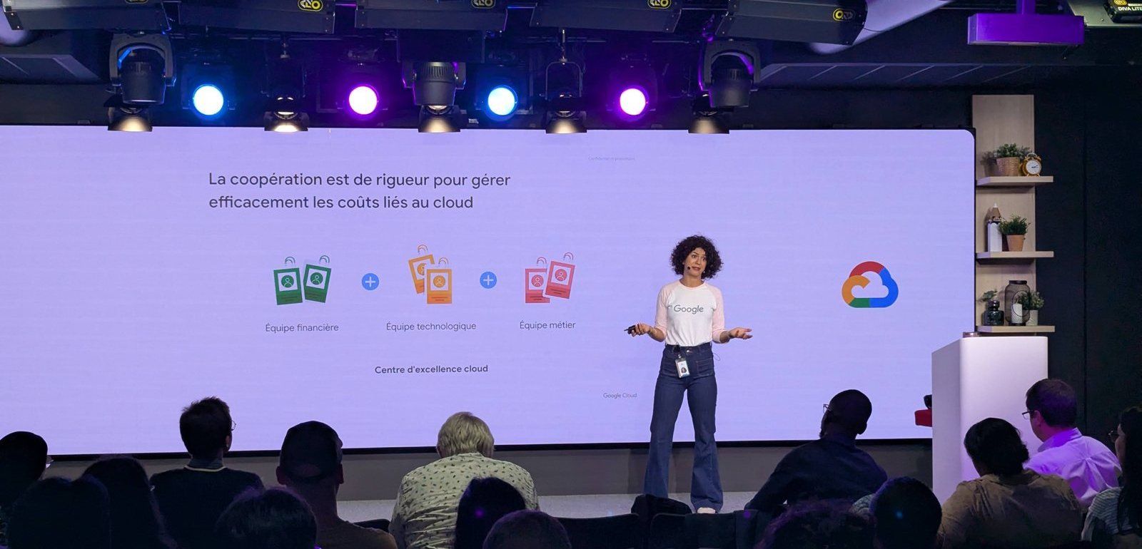 Rita on stage presenting to 400 Google partners in Paris, under the stage lights